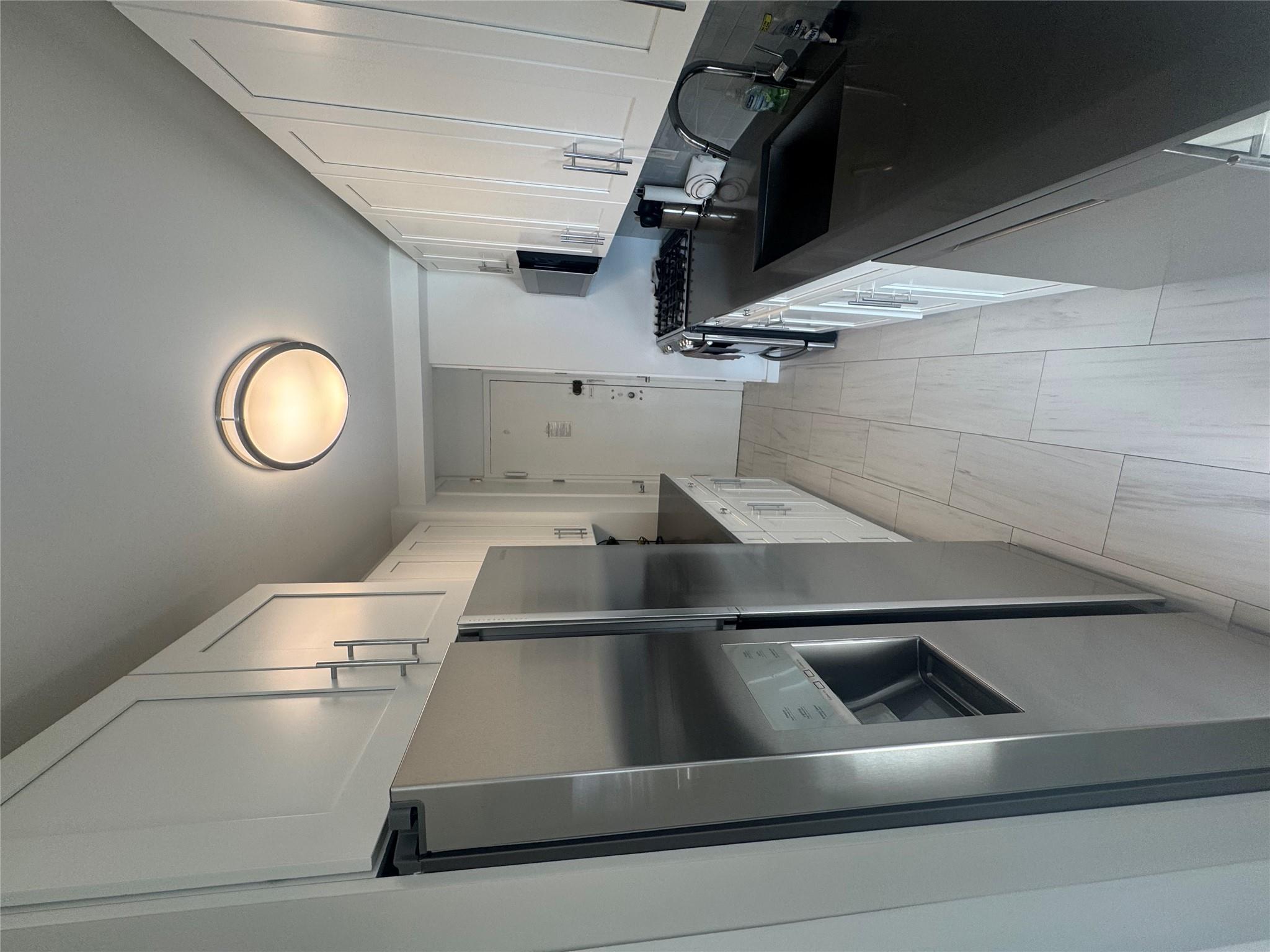 9 Fordham Hill Ovl, Unit 17C Bronx, NY 10468 - Photo 10 of 16 Kitchen with white cabinetry, sink, dishwashing machine, fridge, and stove