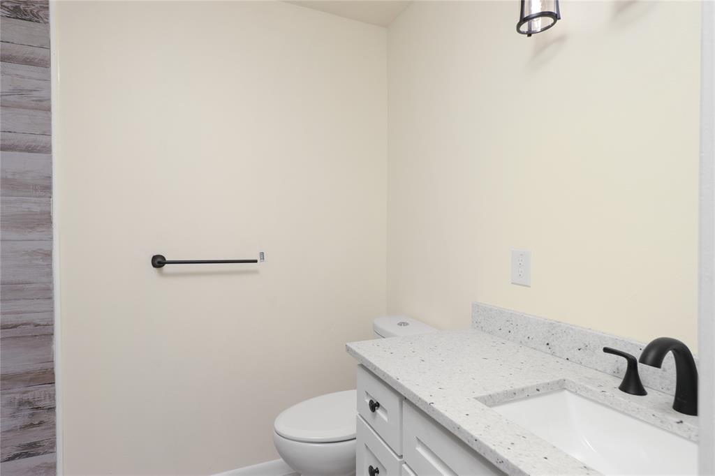 629 Edna Court Everman, TX 76140 - Photo 14 of 24 a bathroom with a sink and mirror