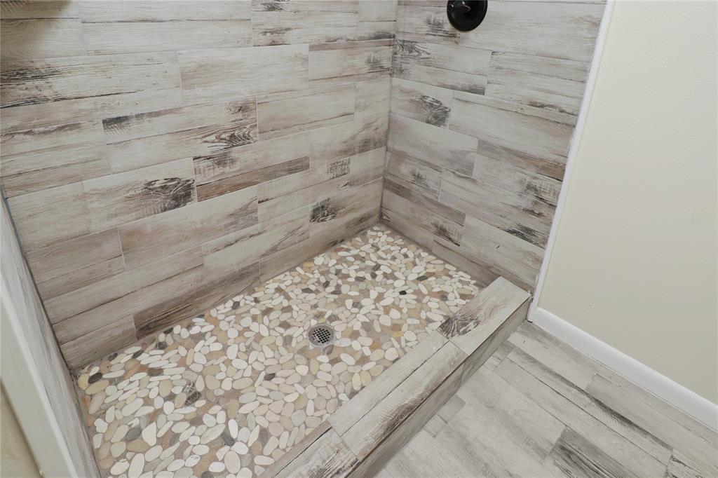 629 Edna Court Everman, TX 76140 - Photo 16 of 24 a bathroom with a shower