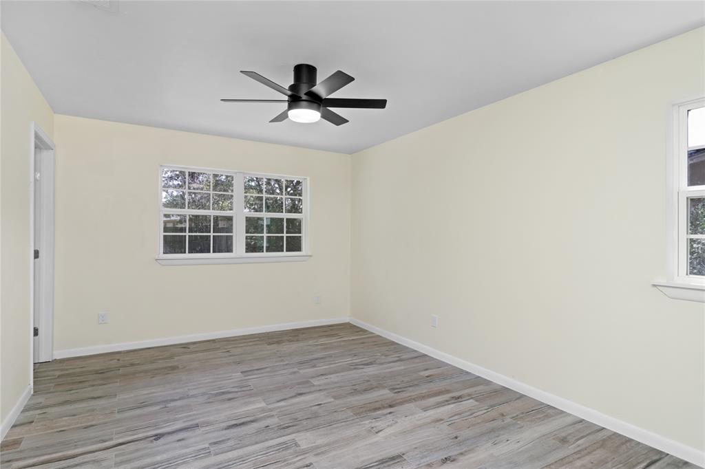 629 Edna Court Everman, TX 76140 - Photo 18 of 24 a view of a big room with wooden floor closet and windows