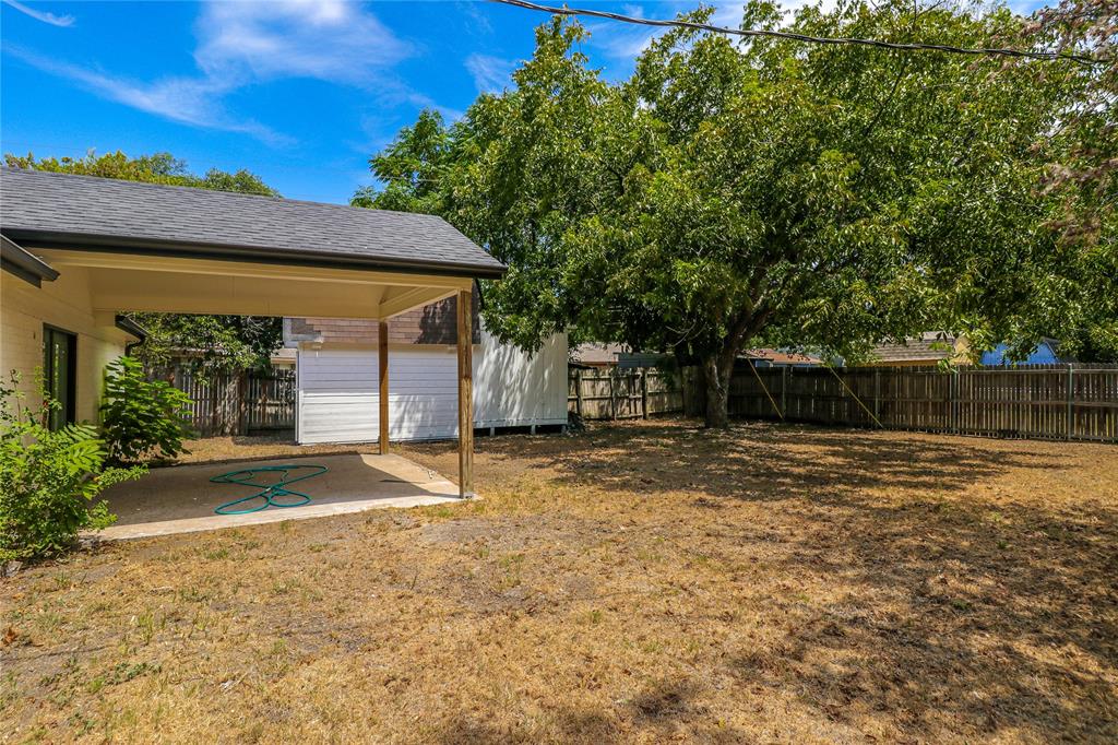 629 Edna Court Everman, TX 76140 - Photo 20 of 24 a view of a backyard with a tree
