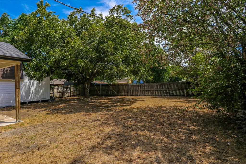 629 Edna Court Everman, TX 76140 - Photo 21 of 24 a backyard of a house with lots of green space