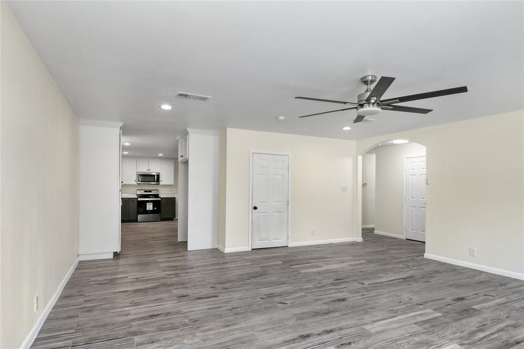 629 Edna Court Everman, TX 76140 - Photo 4 of 24 a view of a livingroom with a ceiling fan hardwood floor and a ceiling fan