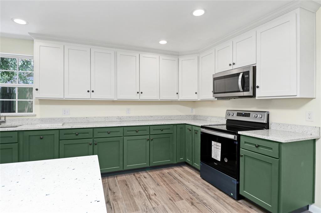 629 Edna Court Everman, TX 76140 - Photo 8 of 24 a kitchen with stainless steel appliances a stove a sink and cabinets