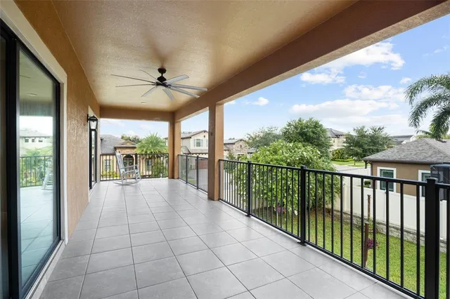an empty room with windows and a ceiling fan