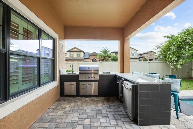 a view of a house with swimming pool and sitting area