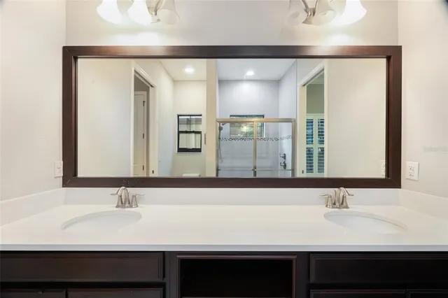 a bathroom with a glass shower door