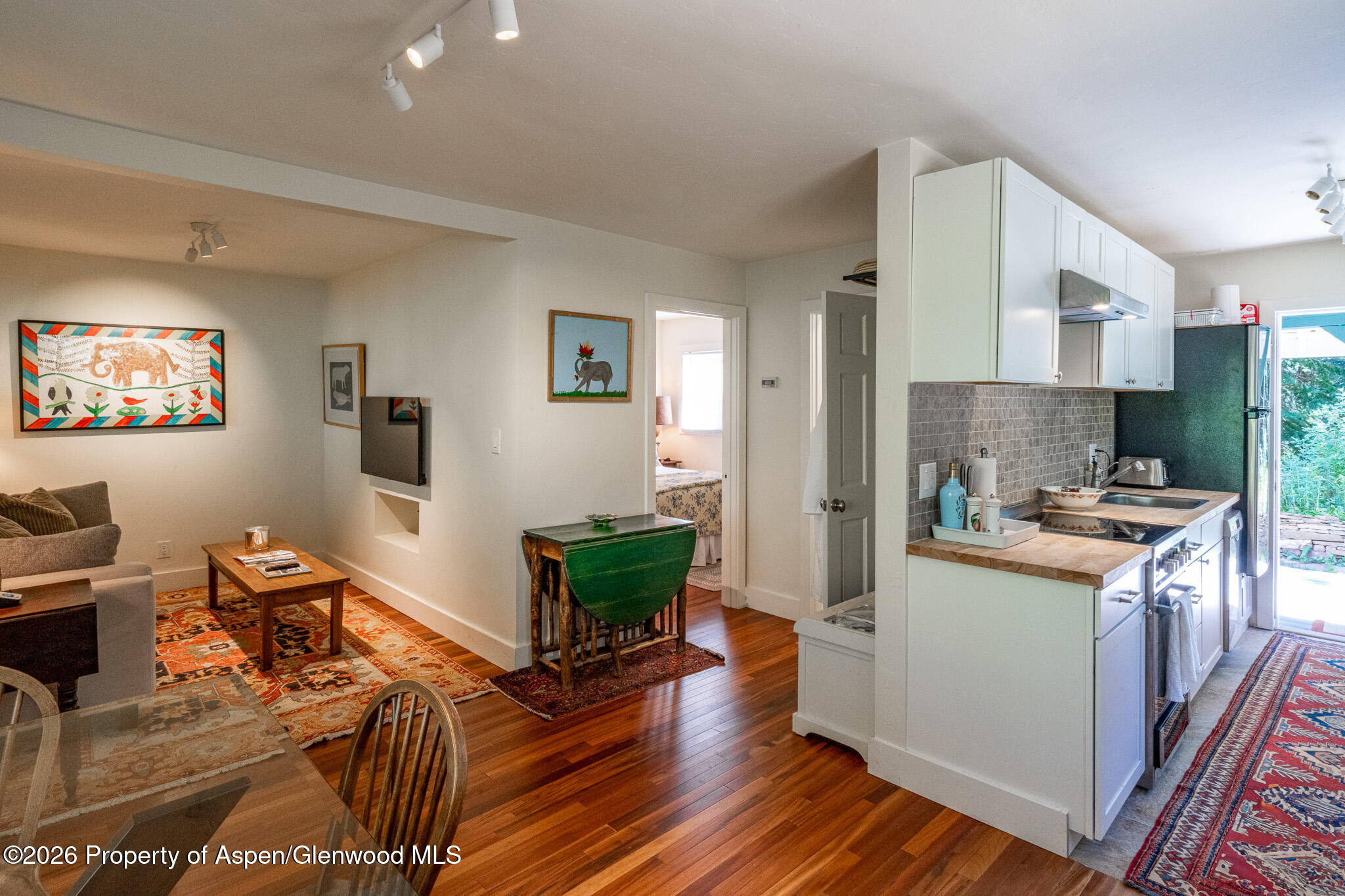 285 Conundrum Creek Road Aspen, CO 81611 - Photo 21 of 35 a kitchen with granite countertop a stove top oven a sink dishwasher and a refrigerator with wooden floor