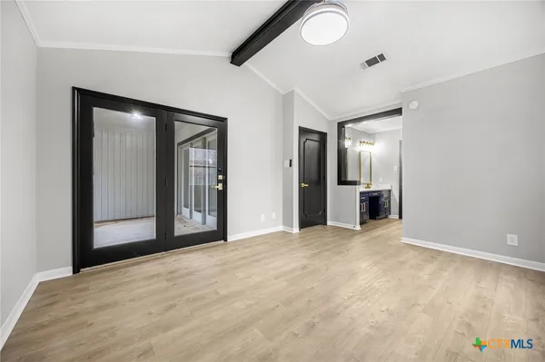 an empty room with closet and windows