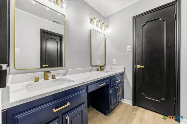 a bathroom with a double vanity sink and a mirror