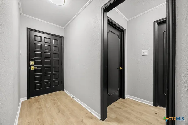 a view of a hallway with closet and wooden floor
