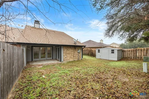 a house with lots of trees in the background