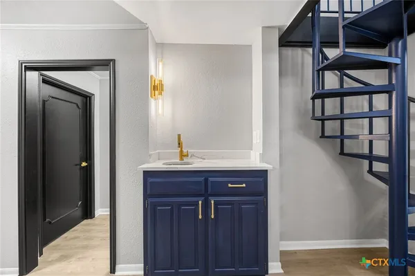 a view of a hallway with wooden floor and entryway