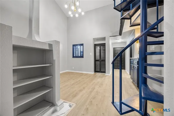 a view of staircase with white walls and wooden floor