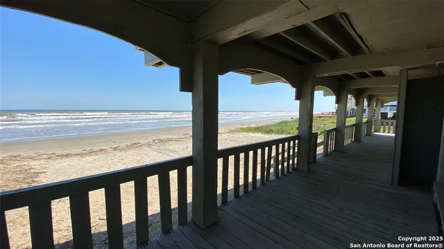 a view of a wooden chairs on the roof deck