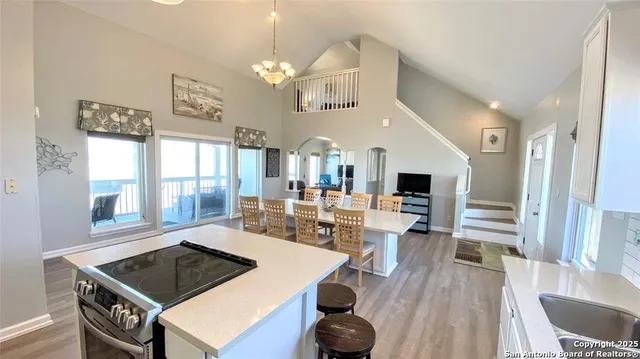 a living room with furniture a flat screen tv and a large window