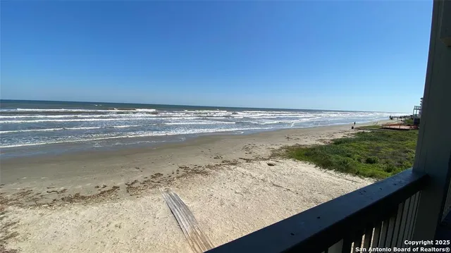 a view of a patio with chair and wooden floor