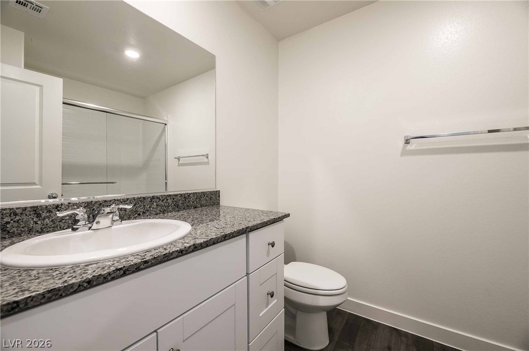 12749 Epperly Street Henderson, NV 89044 - Photo 12 of 22 Modern bathroom featuring granite counters and sleek flooring.