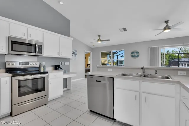 a kitchen with stainless steel appliances granite countertop a sink and stove top oven