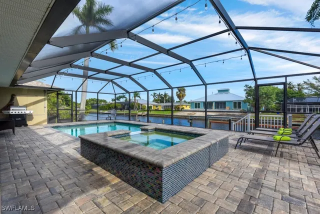 a view of a patio with a table and chairs under an umbrella