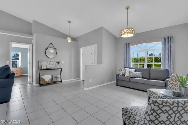 a living room with furniture a window and a chandelier
