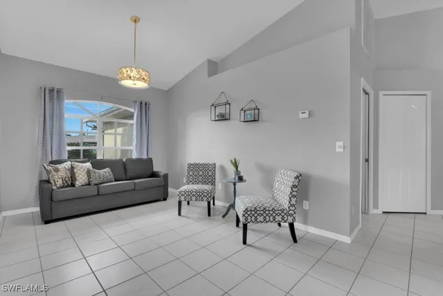 a living room with furniture a dining table and a clock on the wall