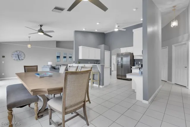 a dining room with kitchen island furniture a kitchen view and stainless steel appliances