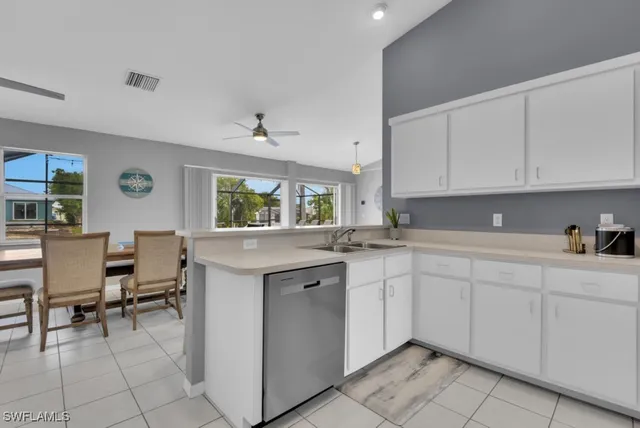 a kitchen with a sink window and cabinets