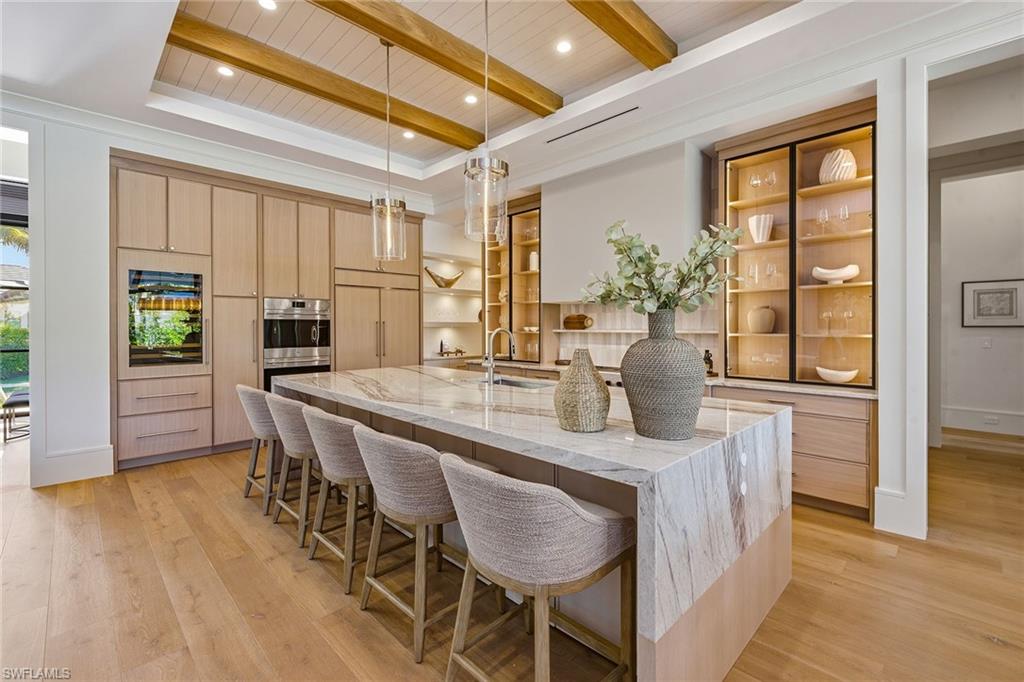 529 Neapolitan Way Naples, FL 34103 - Photo 7 of 26 a dining room with furniture and wooden floor