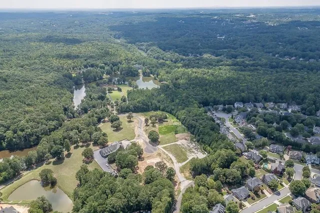 an aerial view of house with yard and mountain view in back