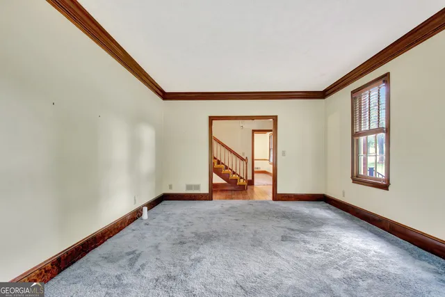 a view of staircase with wooden floor and a floor to ceiling window