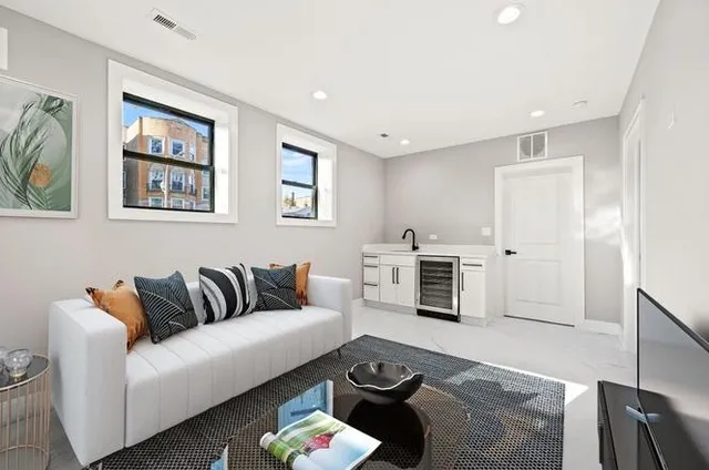 a living room with furniture flat screen tv and a fireplace