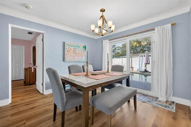 a view of a dining room with furniture window and wooden floor