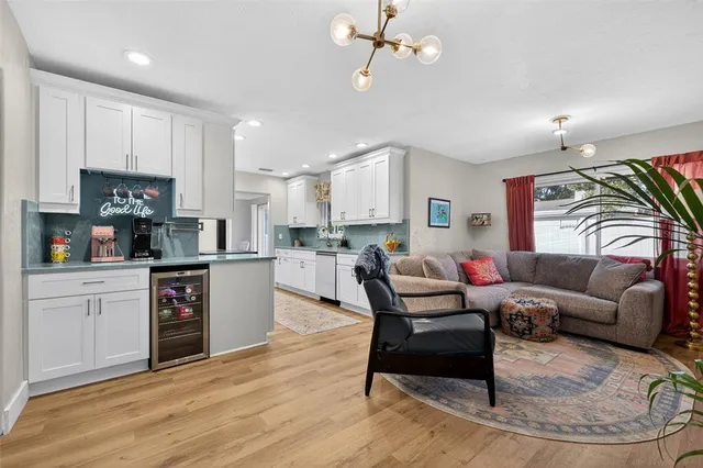 a living room with furniture and kitchen view