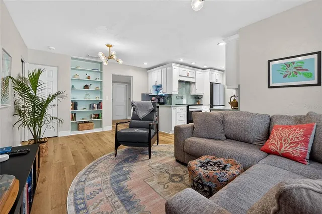 a living room with furniture a large window and a couch