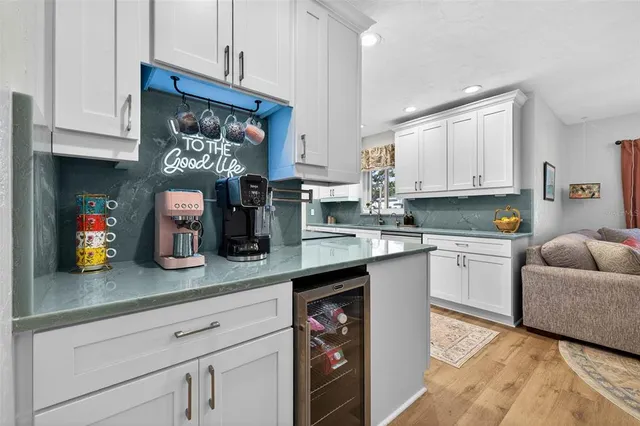 a kitchen with stainless steel appliances granite countertop a sink a stove and cabinets