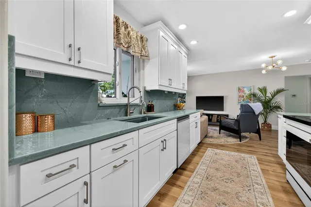 a large white kitchen with lots of counter space
