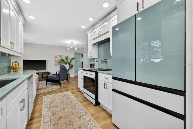 a kitchen with a sink stainless steel appliances and cabinets