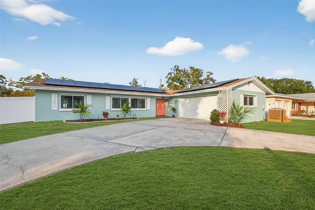 a front view of house with yard and green space