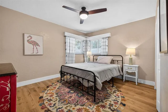 a bedroom with a bed and wooden floor