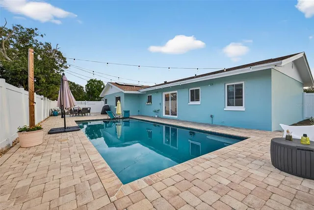a view of a kitchen with a sink and potted plants