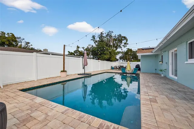 a view of a swimming pool and lounge chair