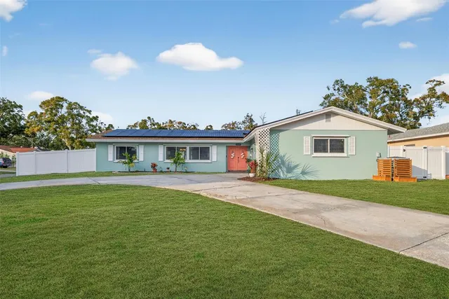 a front view of house with yard and outdoor seating