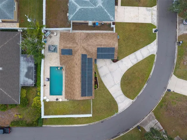 an aerial view of a house with a swimming pool
