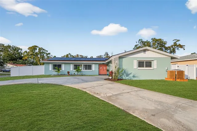 a front view of a house with a garden and yard