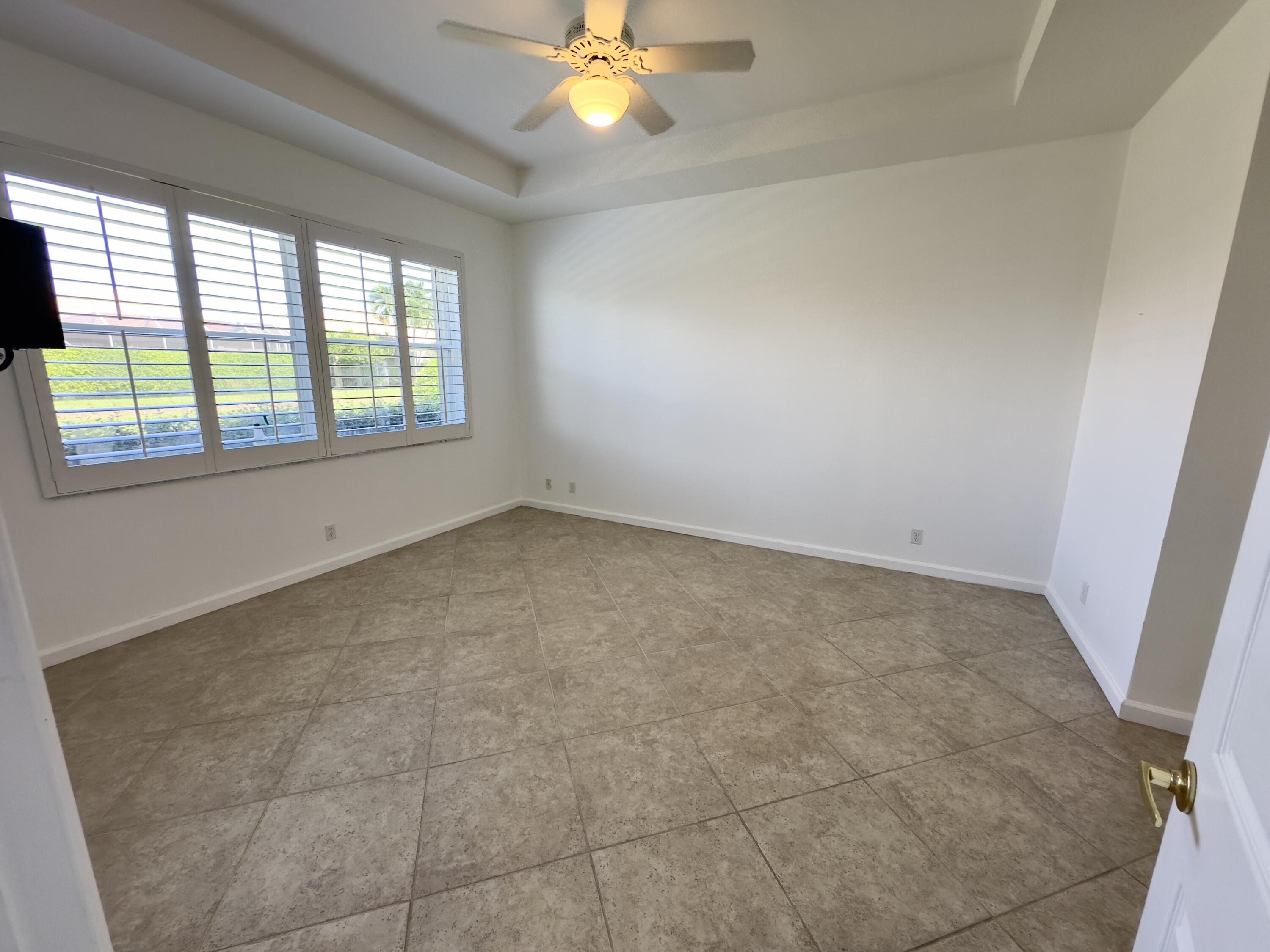 7096 Cataluna Circle Delray Beach, FL 33446 - Photo 9 of 32 a view of an empty room with a window
