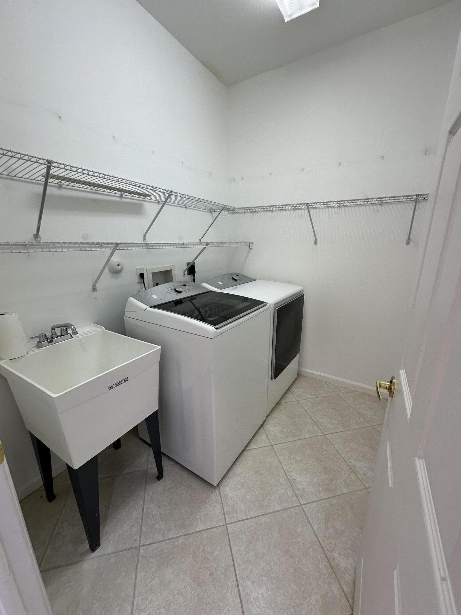 7096 Cataluna Circle Delray Beach, FL 33446 - Photo 15 of 32 a utility room with dryer and washer