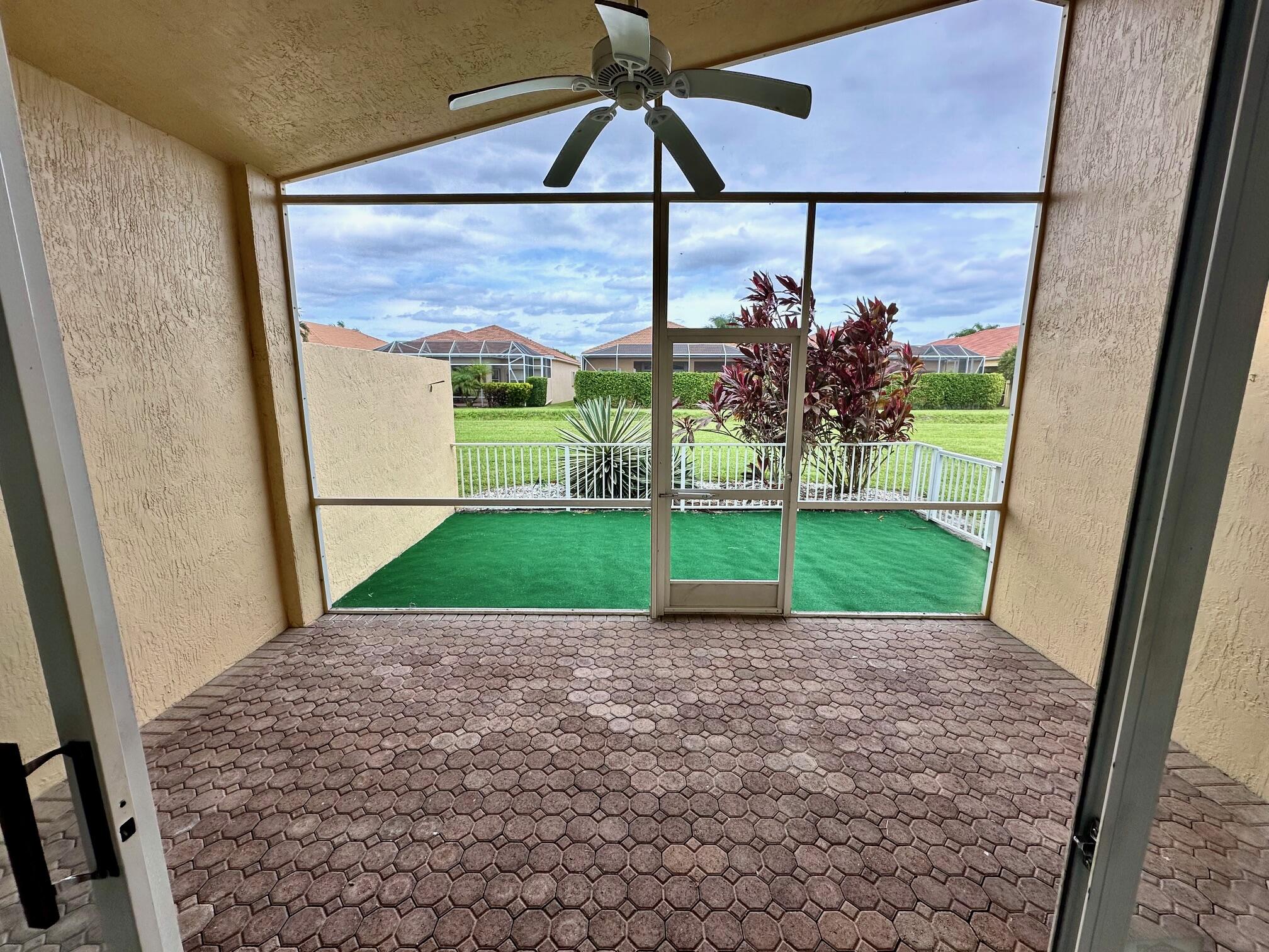 7096 Cataluna Circle Delray Beach, FL 33446 - Photo 16 of 32 a view of a porch with a table and chairs