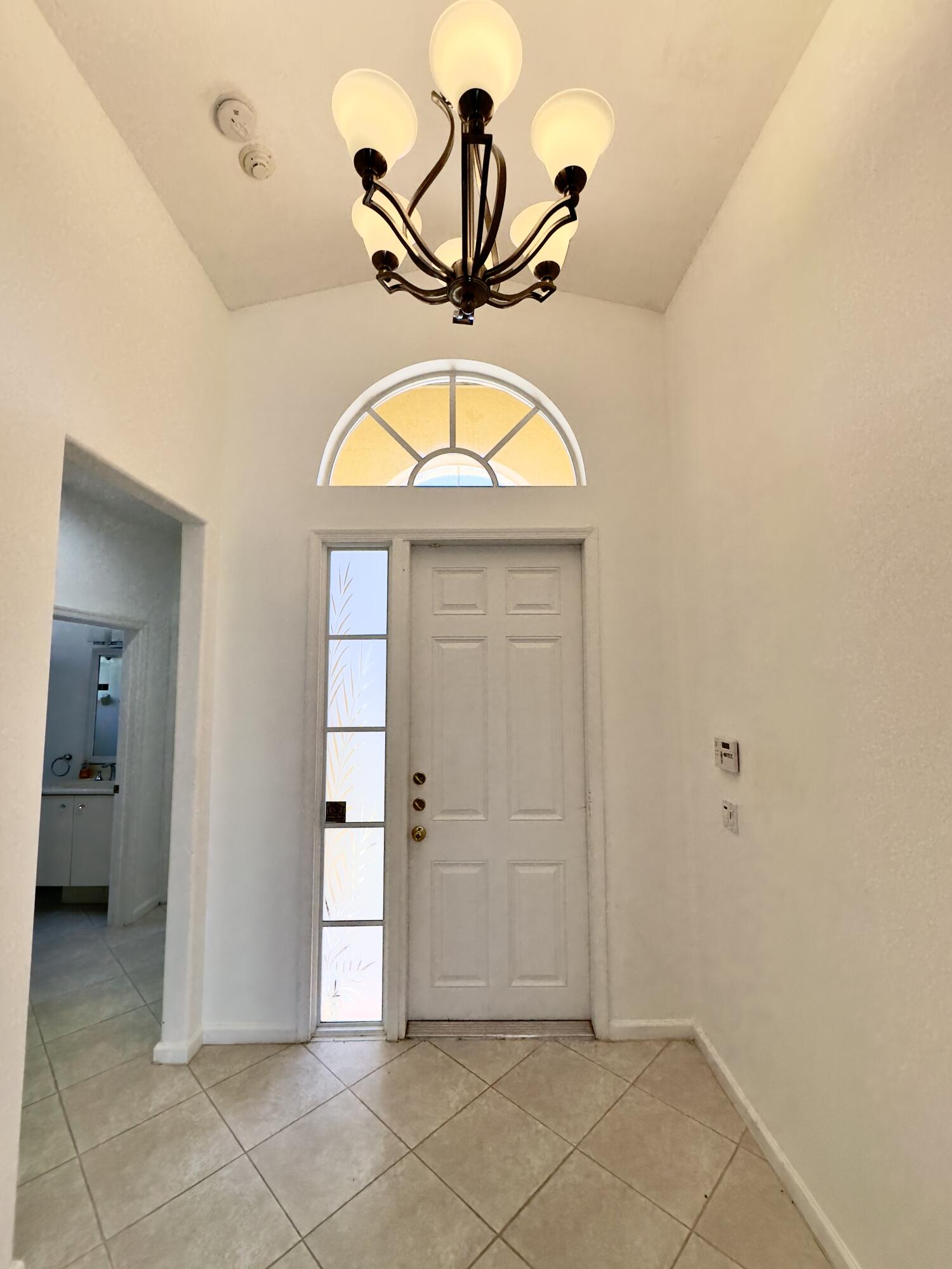 7096 Cataluna Circle Delray Beach, FL 33446 - Photo 19 of 32 a view of a livingroom with a hanging light and hardwood