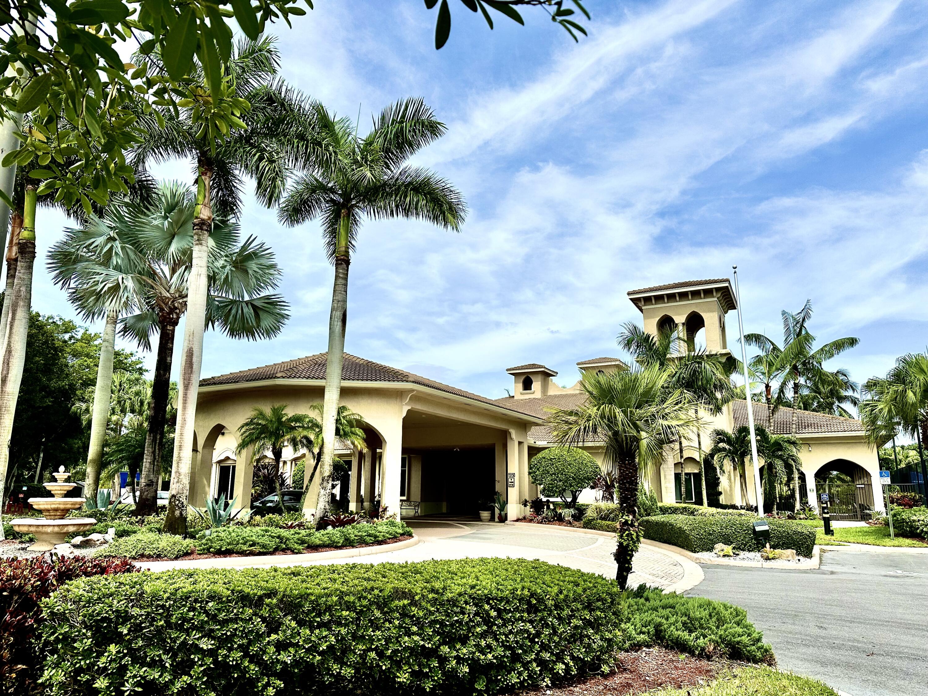 7096 Cataluna Circle Delray Beach, FL 33446 - Photo 23 of 32 a front view of a house with garden